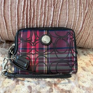 Coach Signature Plaid Wristlet in magenta, blue, and black.